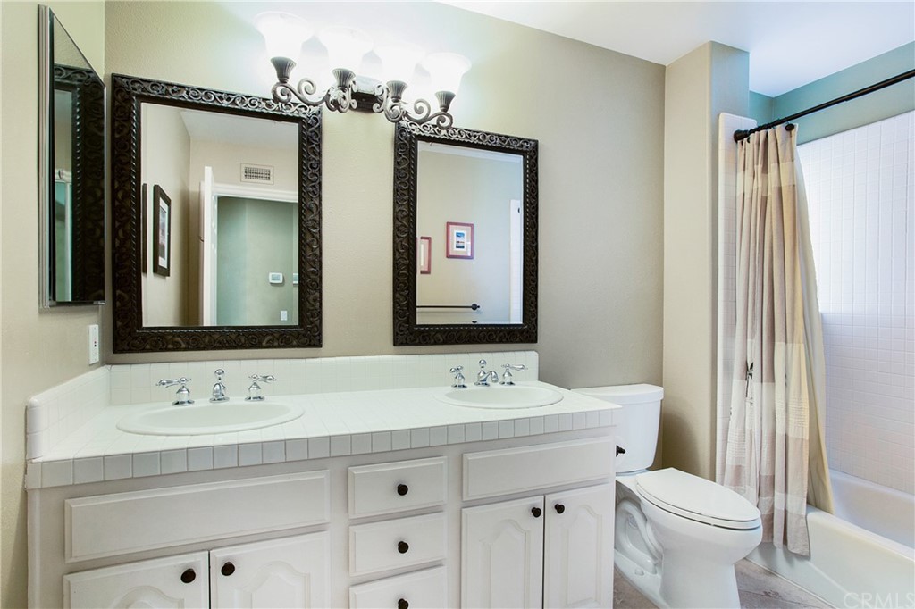 16 Bethany Laguna Niguel, CA 92677 - Photo 29 of 38 a bathroom with a sink a toilet and a mirror