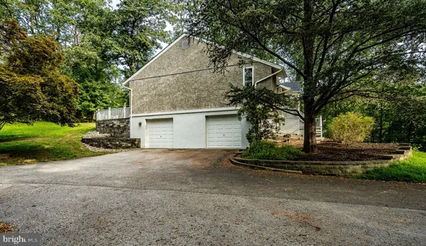 a view of a house with a yard and garage