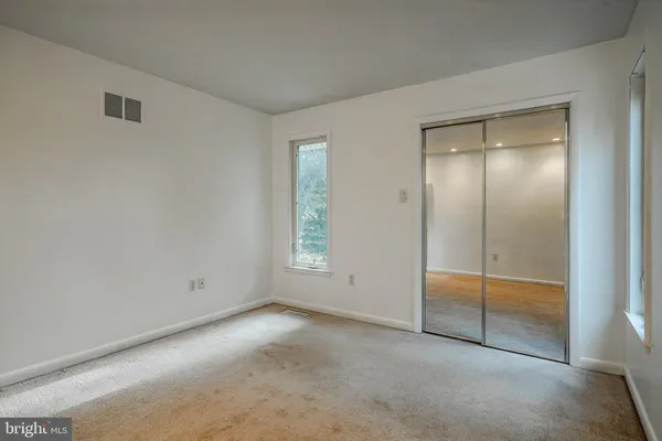 an empty room with a mirror