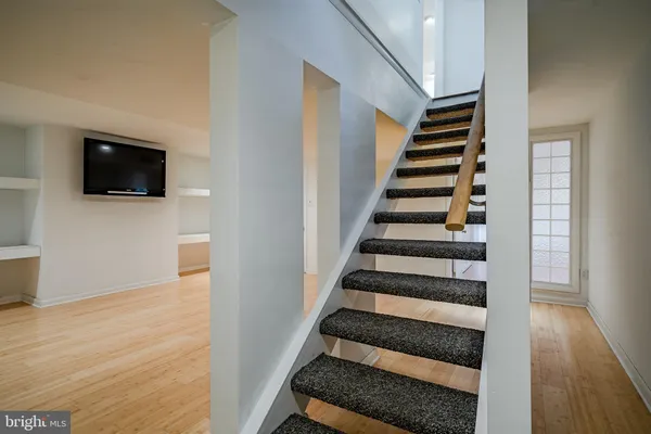 a view of a hallway with wooden floor and a fireplace