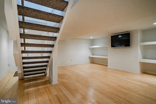 a view of entryway with wooden floor and stairs