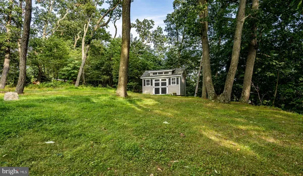 a backyard of a house with lots of green space and fountain