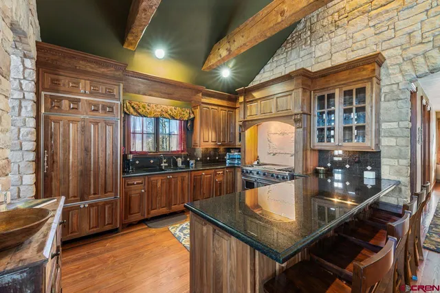 a kitchen with stainless steel appliances granite countertop a stove and a sink