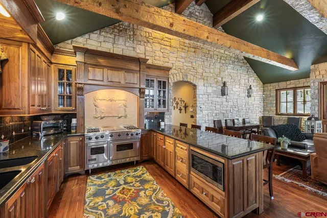 a bedroom with a large bed and wooden floor