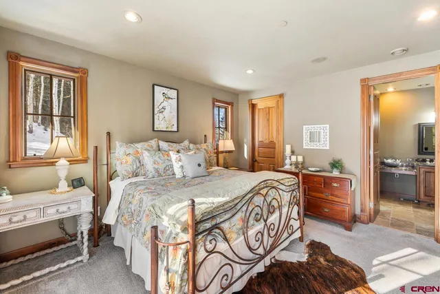 a bathroom with a granite countertop sink a mirror and a shower