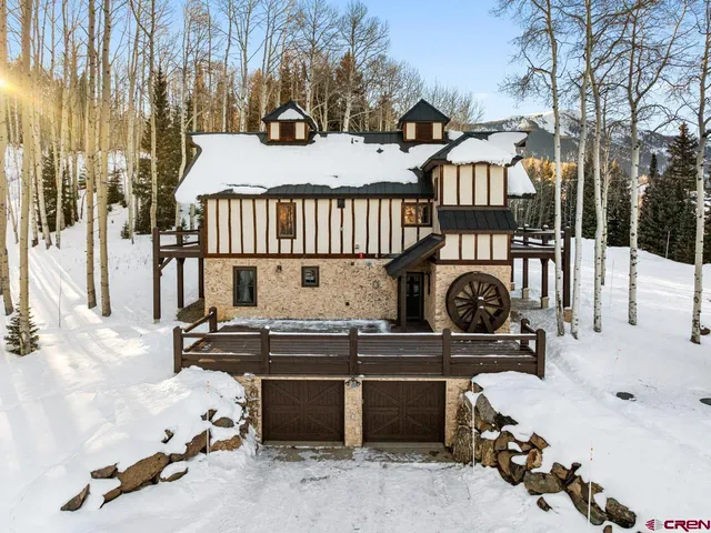 a view of a house with wooden fence