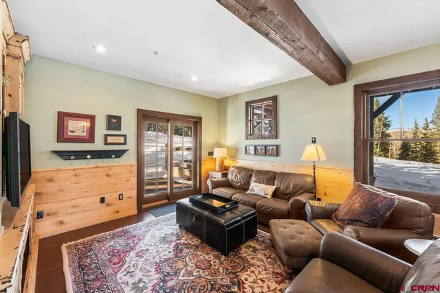 a room with furniture pool table and glass door