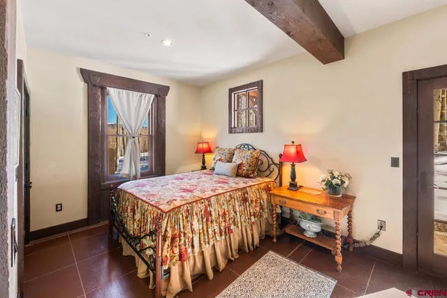 a bedroom with two beds and a dresser