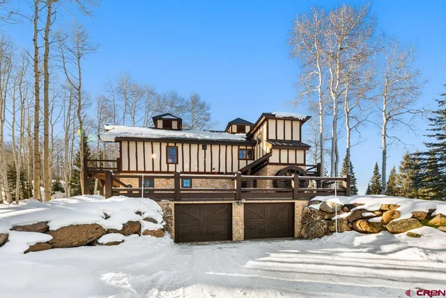 a view of a balcony with chairs and wooden fence