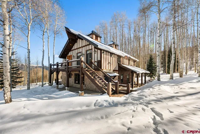 a view of a house with wooden fence next to a road