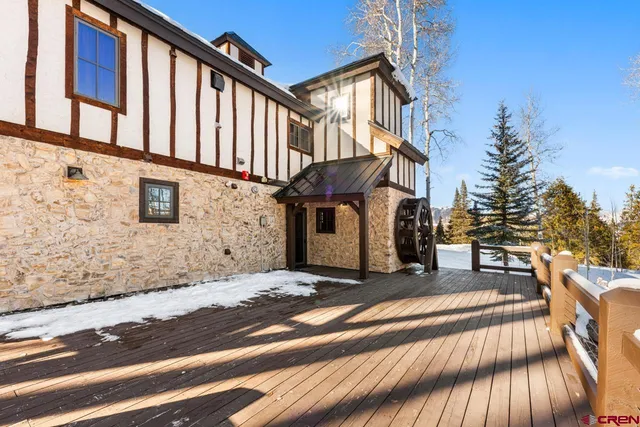 a view of a building with stairs and a car parked on the road