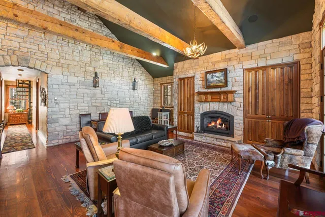 a living room with furniture a fireplace and a table