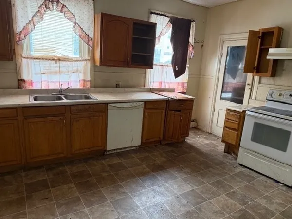 a kitchen with stainless steel appliances granite countertop a sink stove and microwave