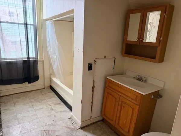 a bathroom with a sink a toilet and a mirror