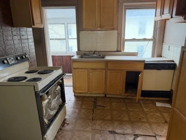 a kitchen with a stove a sink and a refrigerator