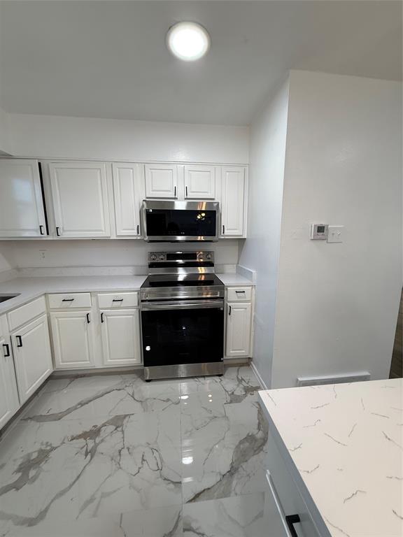 2529 Rutgers Drive Irving, TX 75062 - Photo 14 of 38 a kitchen with granite countertop a stove a sink and a granite counter tops