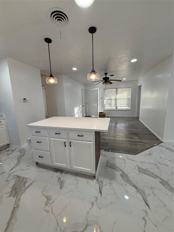 2529 Rutgers Drive Irving, TX 75062 - Photo 15 of 38 a hall with a stove a sink dishwasher a dining table chairs and chandelier