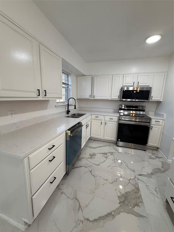 2529 Rutgers Drive Irving, TX 75062 - Photo 16 of 38 a kitchen with granite countertop a stove sink and cabinets