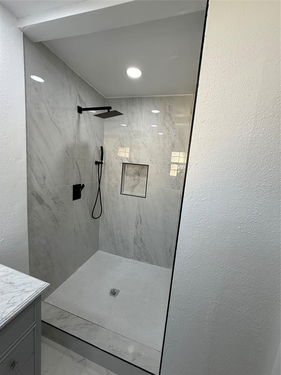 2529 Rutgers Drive Irving, TX 75062 - Photo 2 of 38 a bathroom with a shower and a sink