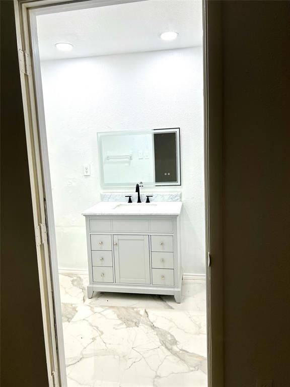 2529 Rutgers Drive Irving, TX 75062 - Photo 21 of 38 a bathroom with a sink toilet and mirror