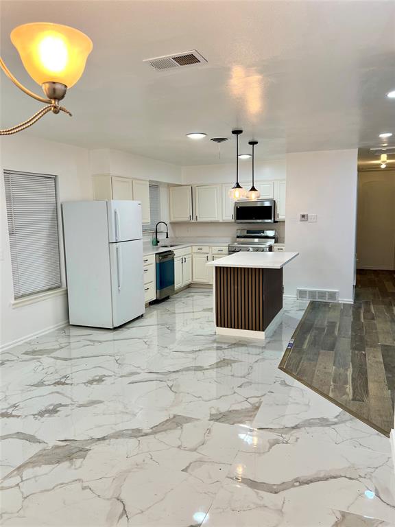 2529 Rutgers Drive Irving, TX 75062 - Photo 28 of 38 a kitchen with kitchen island granite countertop a stove and a sink