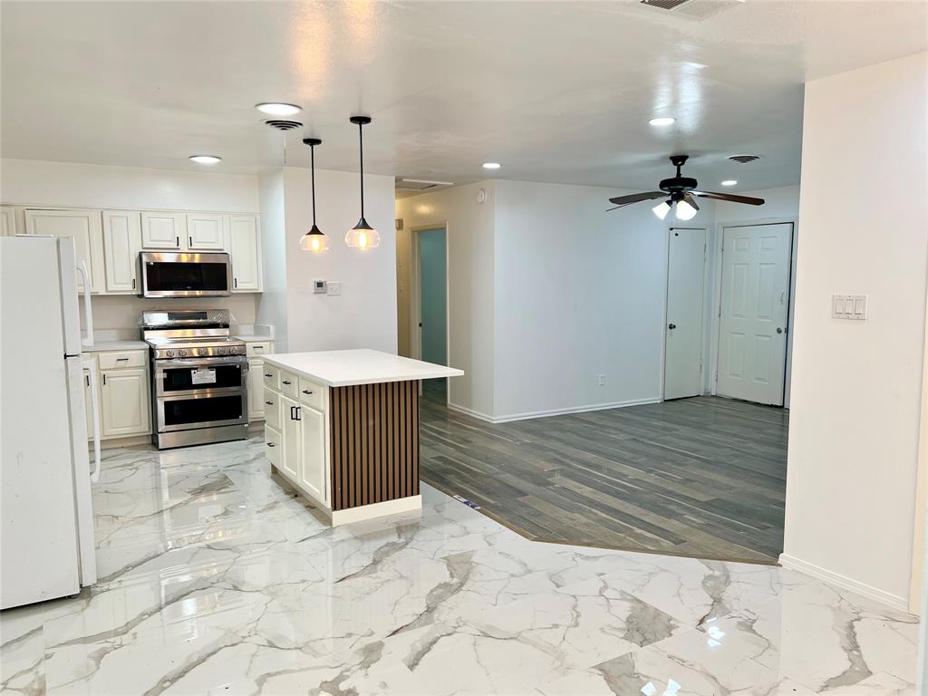 2529 Rutgers Drive Irving, TX 75062 - Photo 29 of 38 a large kitchen with kitchen island a sink stainless steel appliances and cabinets