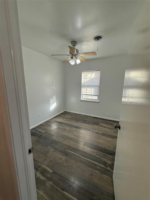 2529 Rutgers Drive Irving, TX 75062 - Photo 7 of 38 a view of an empty room and window and ceiling fan