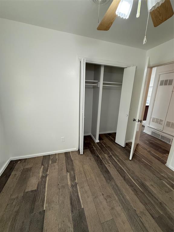 2529 Rutgers Drive Irving, TX 75062 - Photo 10 of 38 an empty room with wooden floor and windows