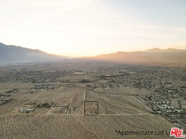 a view of a dry yard with mountain