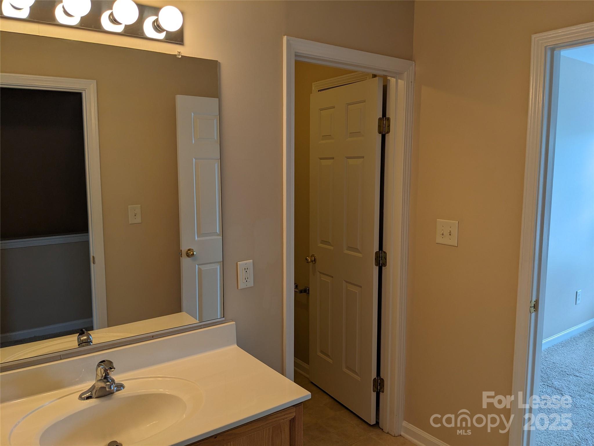 4934 Prosperity Ridge Road Charlotte, NC 28269 - Photo 11 of 15 a bathroom with a sink and a mirror