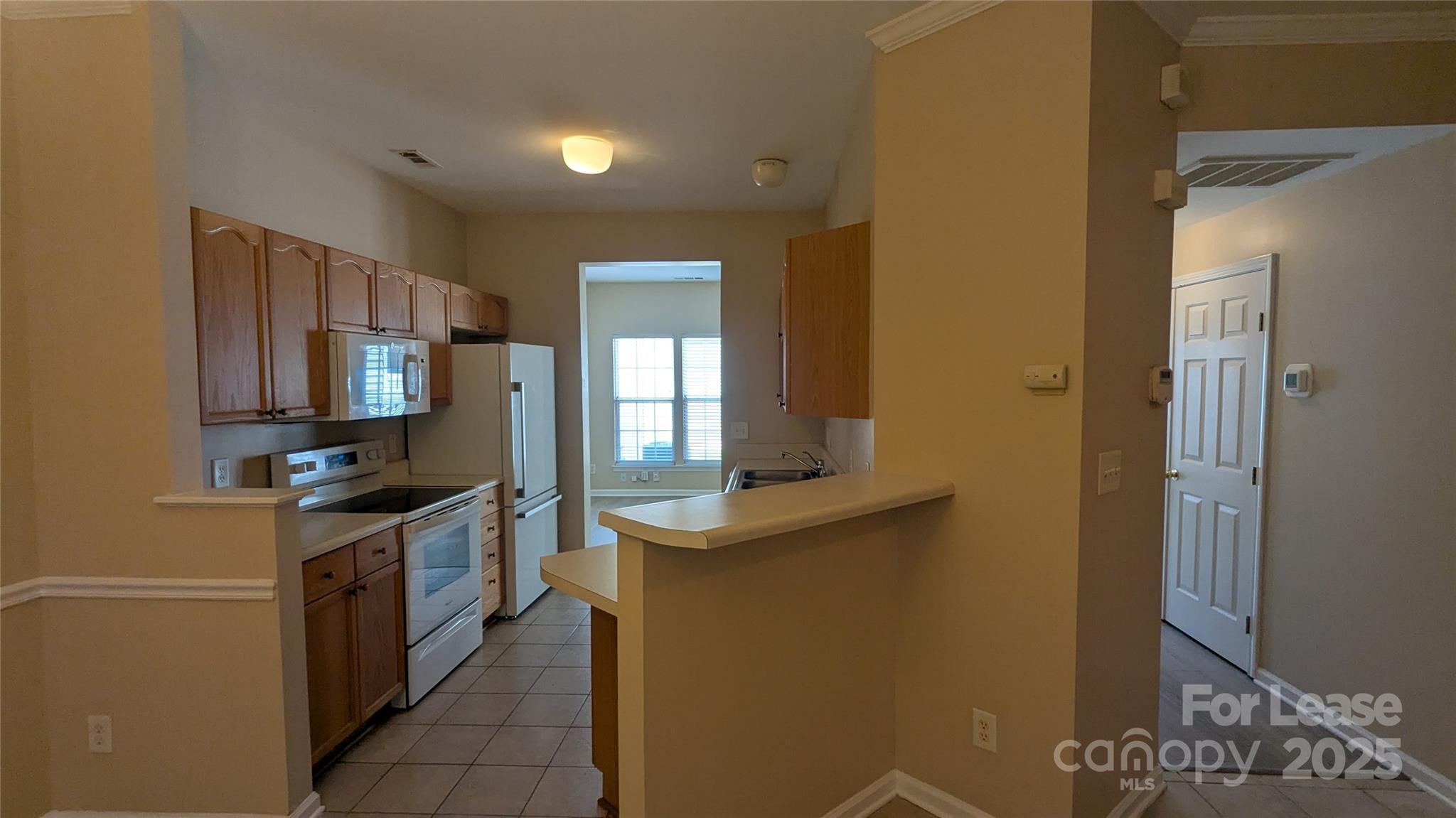 4934 Prosperity Ridge Road Charlotte, NC 28269 - Photo 3 of 15 a kitchen with stainless steel appliances granite countertop a stove a sink and a refrigerator