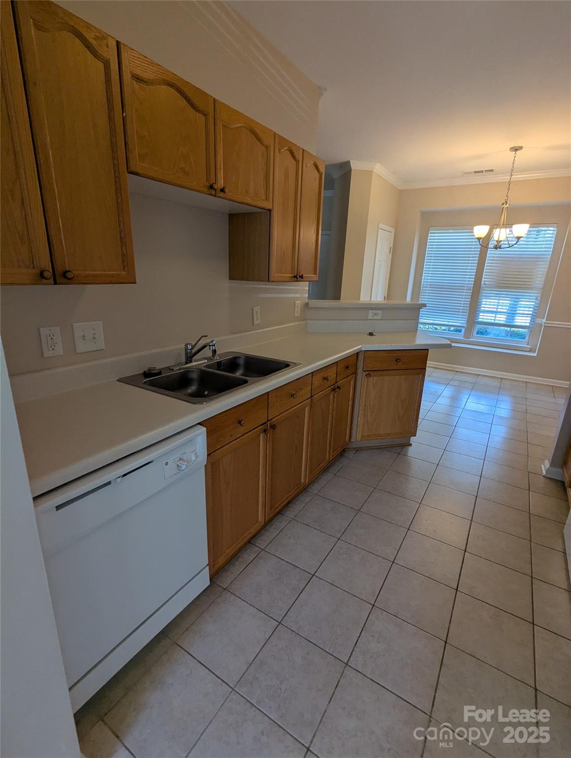 4934 Prosperity Ridge Road Charlotte, NC 28269 - Photo 4 of 15 a kitchen with a sink a stove top oven and cabinetry