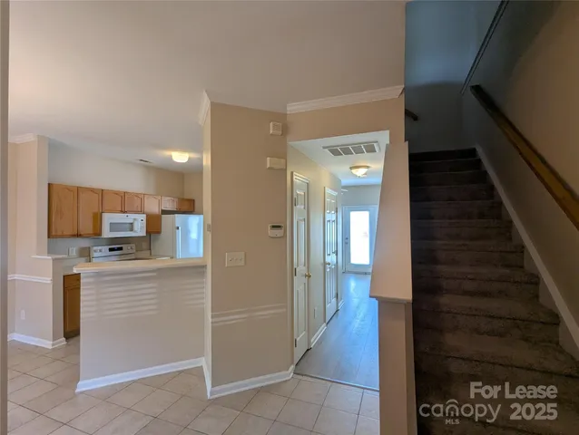 a view of a hallway to a kitchen