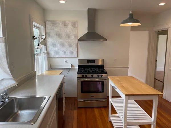 a kitchen with a stove and a refrigerator
