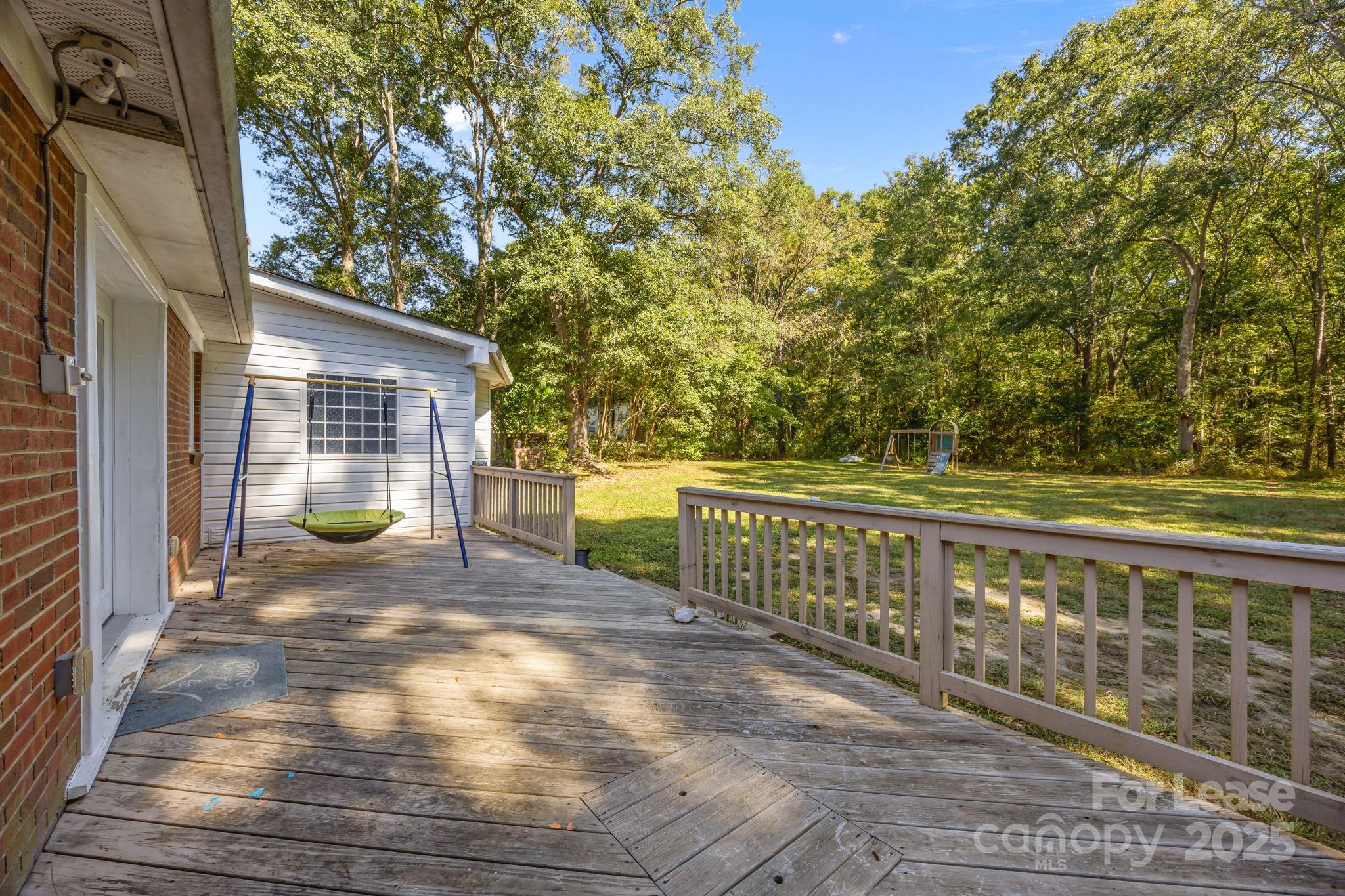 10751 Ola Drive Fort Mill, SC 29707 - Photo 15 of 22 a view of a brick house with large windows and a yard