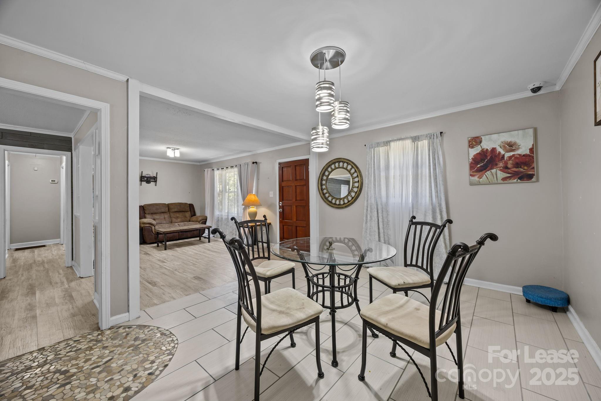 10751 Ola Drive Fort Mill, SC 29707 - Photo 5 of 22 a view of a dining room and kitchen a chandelier a wooden table and chairs
