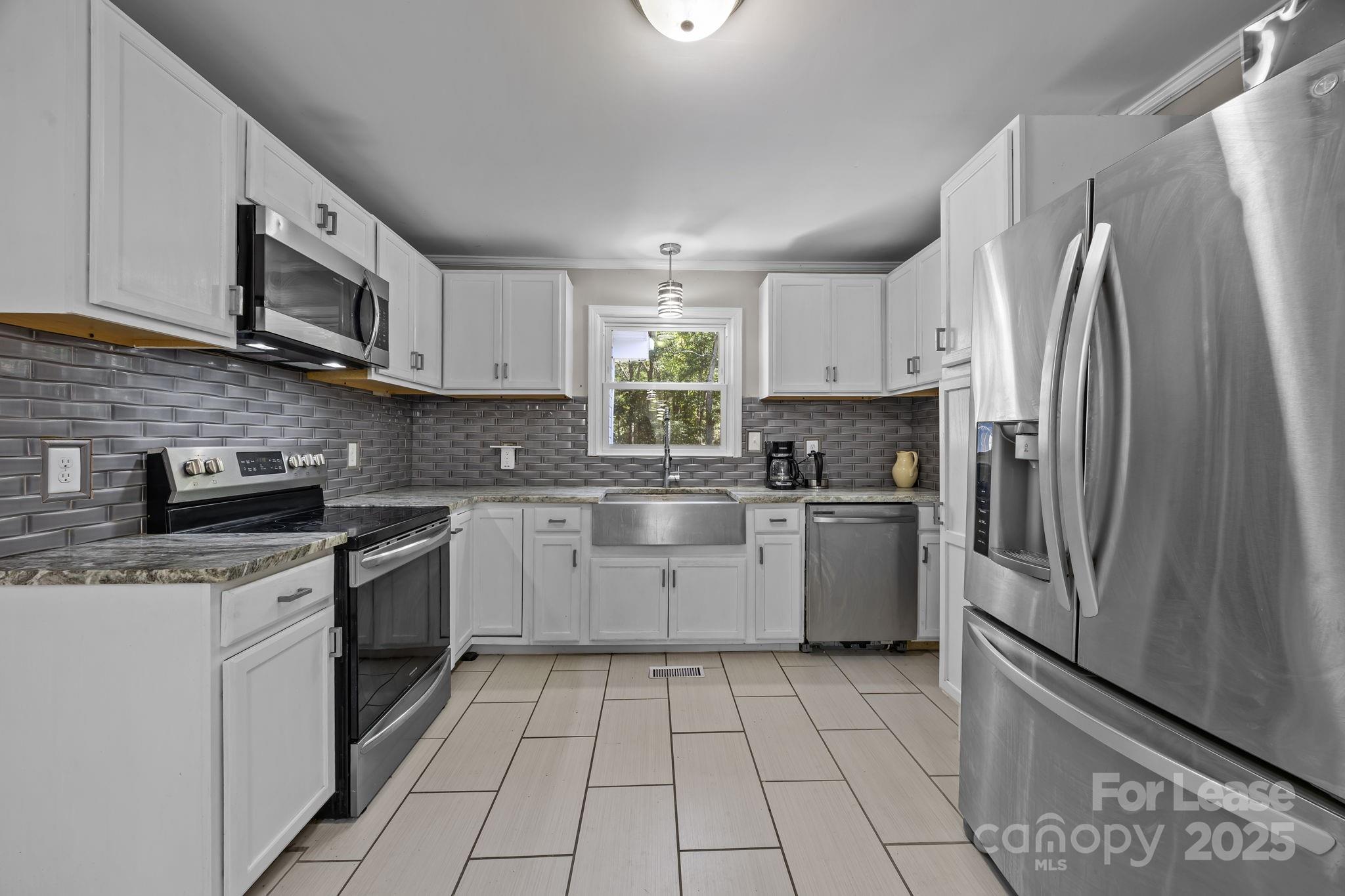 10751 Ola Drive Fort Mill, SC 29707 - Photo 6 of 22 a kitchen with a sink a refrigerator and cabinets