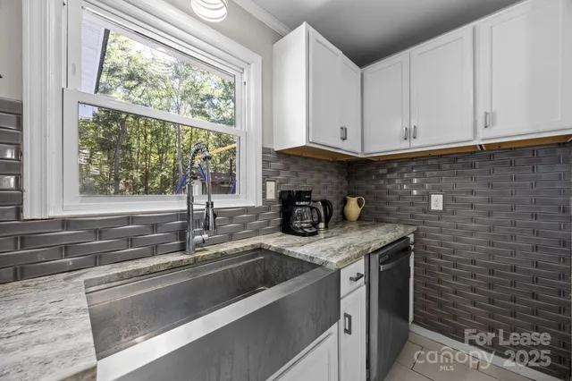 a kitchen with stainless steel appliances a sink stove and window