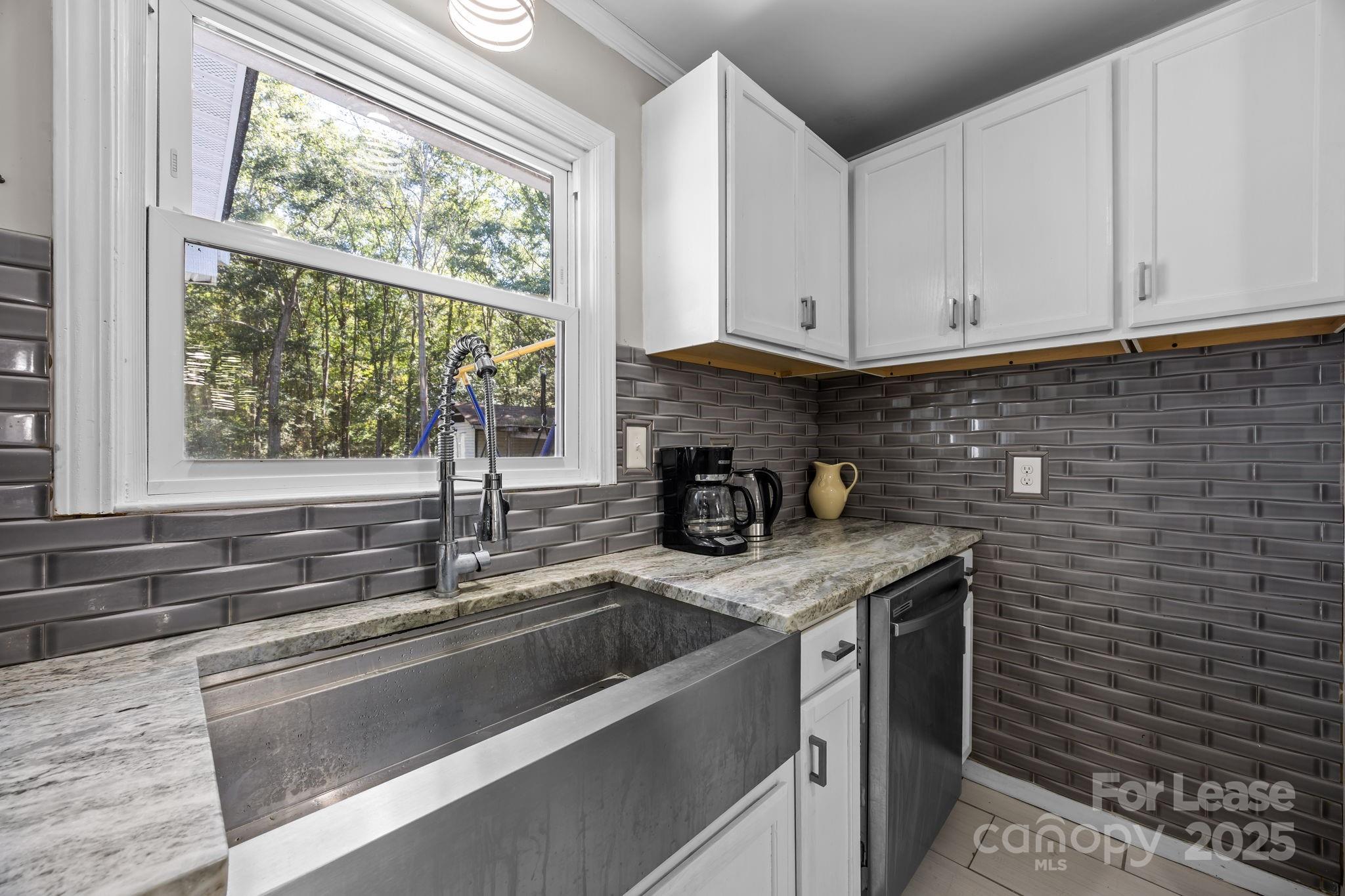 10751 Ola Drive Fort Mill, SC 29707 - Photo 7 of 22 a kitchen with stainless steel appliances a sink stove and window
