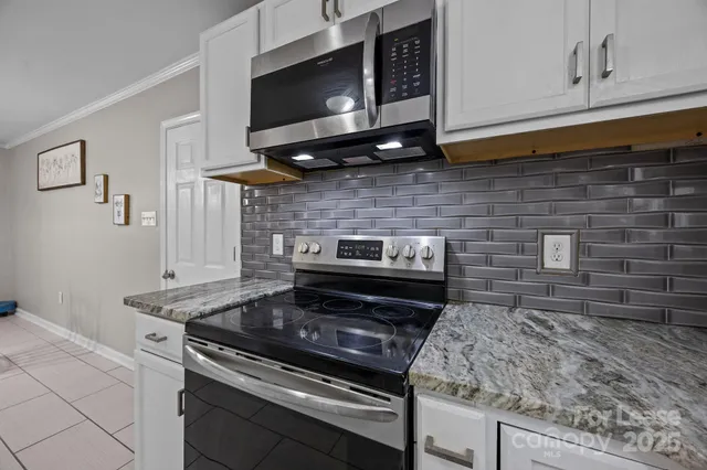 a kitchen with a stove and a microwave