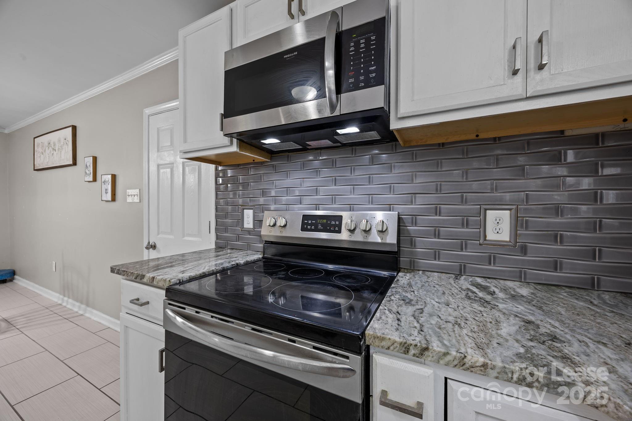 10751 Ola Drive Fort Mill, SC 29707 - Photo 8 of 22 a kitchen with a stove and a microwave