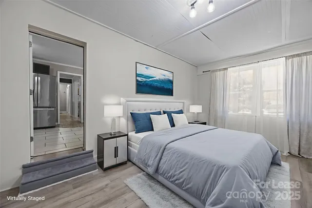 a bedroom with a bed and a mirror