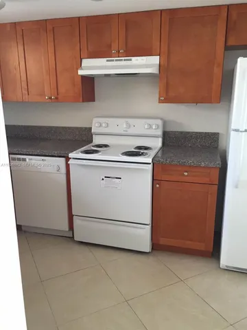 a stove top oven sitting inside of a kitchen