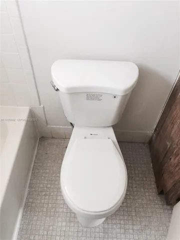 a bathroom with a toilet and a bathtub