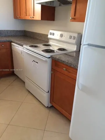 a stove top oven sitting inside of a kitchen
