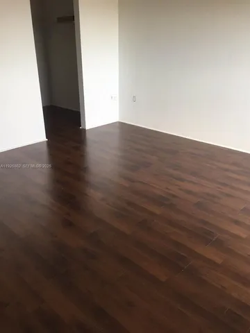 an empty room with wooden floor