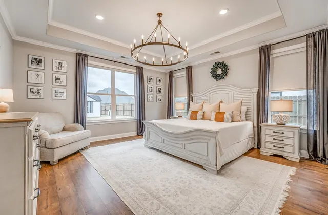 a bedroom with a bed mirror and a large window