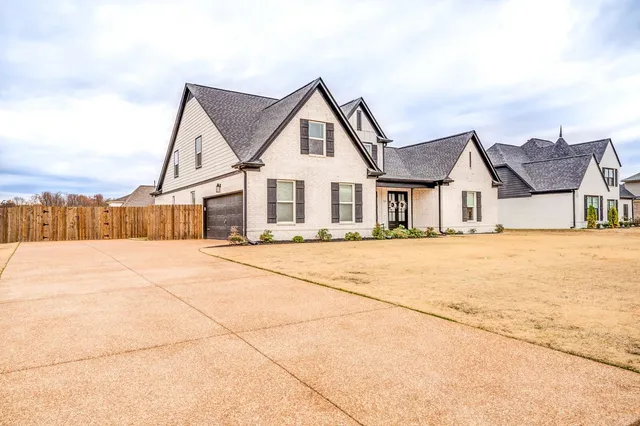 a house with large trees in front of it