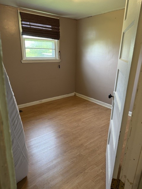 166 Indiana Avenue Ethridge, TN 38456 - Photo 15 of 18 a view of an empty room with wooden floor and a window