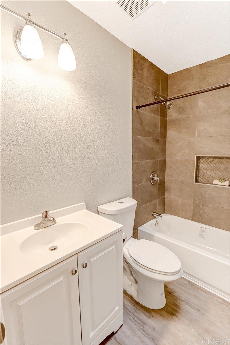 8186 Lemon Grove Way, Unit E Lemon Grove, CA 91945 - Photo 13 of 20 a bathroom with a sink a toilet and shower